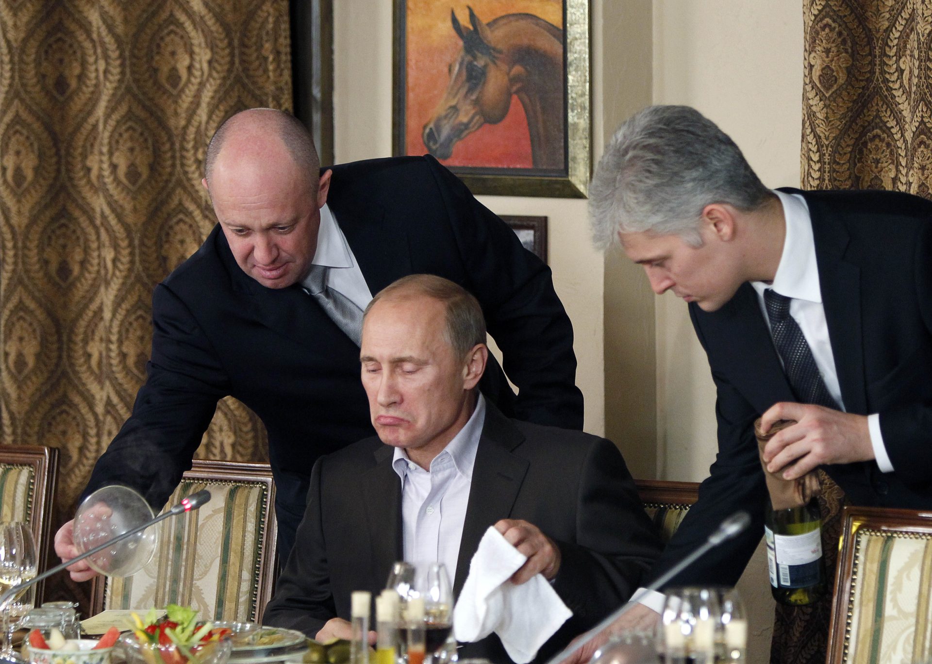 Yevgeny Prigozhin, the owner of the Wagner Group military company FILE - Businessman Yevgeny Prigozhin, left, serves food to Russian Prime Minister Vladimir Putin, center, during dinner at Prigozhin\'s restaurant outside Moscow, Russia, Friday, Nov. 11, 2011. Russia has engaged in under-the-radar military operations in at least half a dozen countries in Africa in the last five years using a shadowy mercenary force, Wagner, analysts say is loyal to President Vladimir Putin. The United States identifies Prigozhin as Wagner\'s financer. (AP Photo/Misha Japaridze, Pool, File)