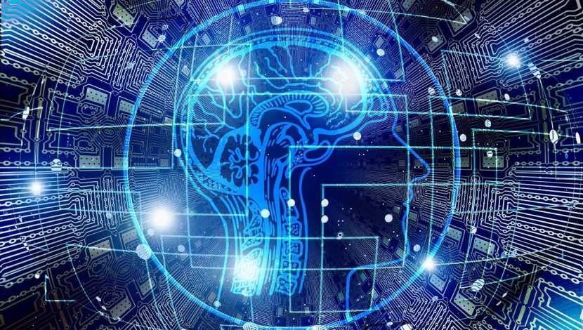 Un cerchio azzurro su sfondo blu, con dentro un cervello stilizzato azzurro, varie linee azzurre e luminose che simulano connessioni del computer