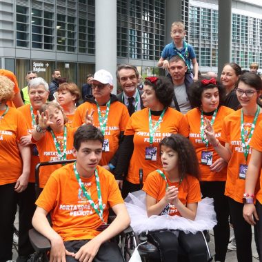 Attilio Fontana con un gruppo di persone con disabilità nel 2022 in occasione dell'esibizione di mototerapia con il campione di motocross Vanni Oddera