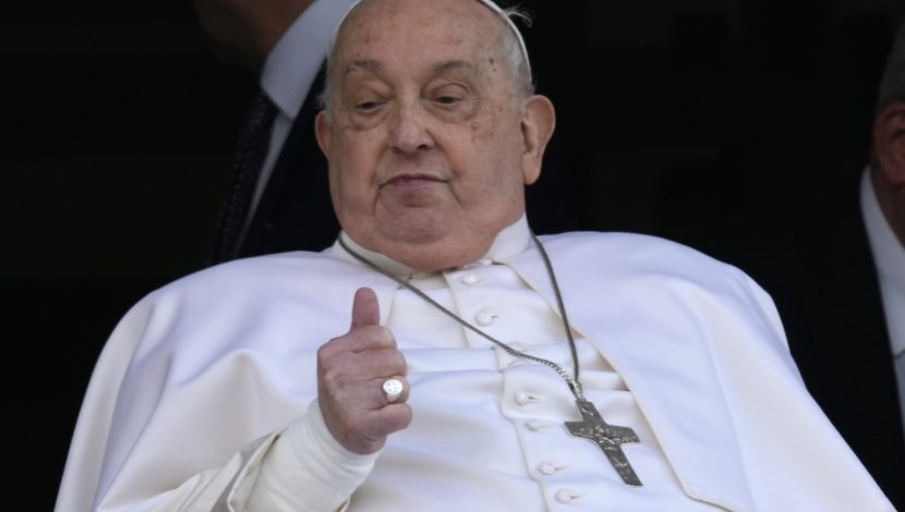 Pope Francis gives the thumbs up as he appears at a window of the Agostino Gemelli Polyclinic in Rome, Sunday, March 23, 2025